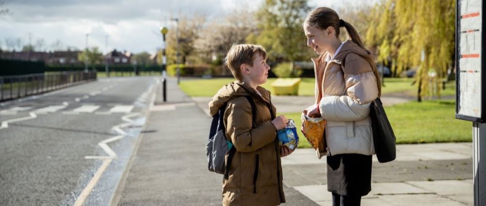 Students waiting for a school bus